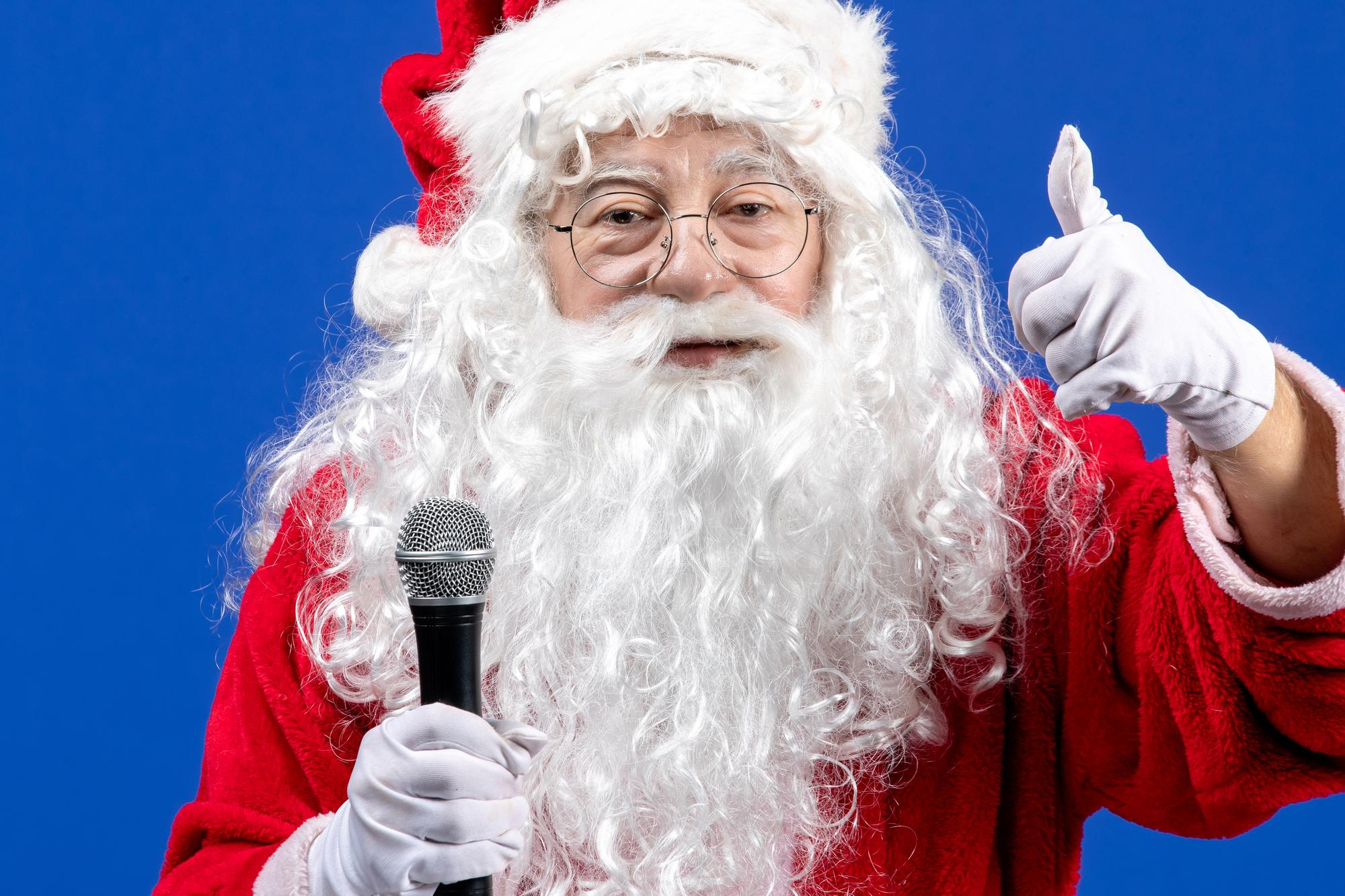 front-view-santa-claus-with-red-suit-white-beard-holding-mic-blue-color-holiday-xmas-new-year.jpg