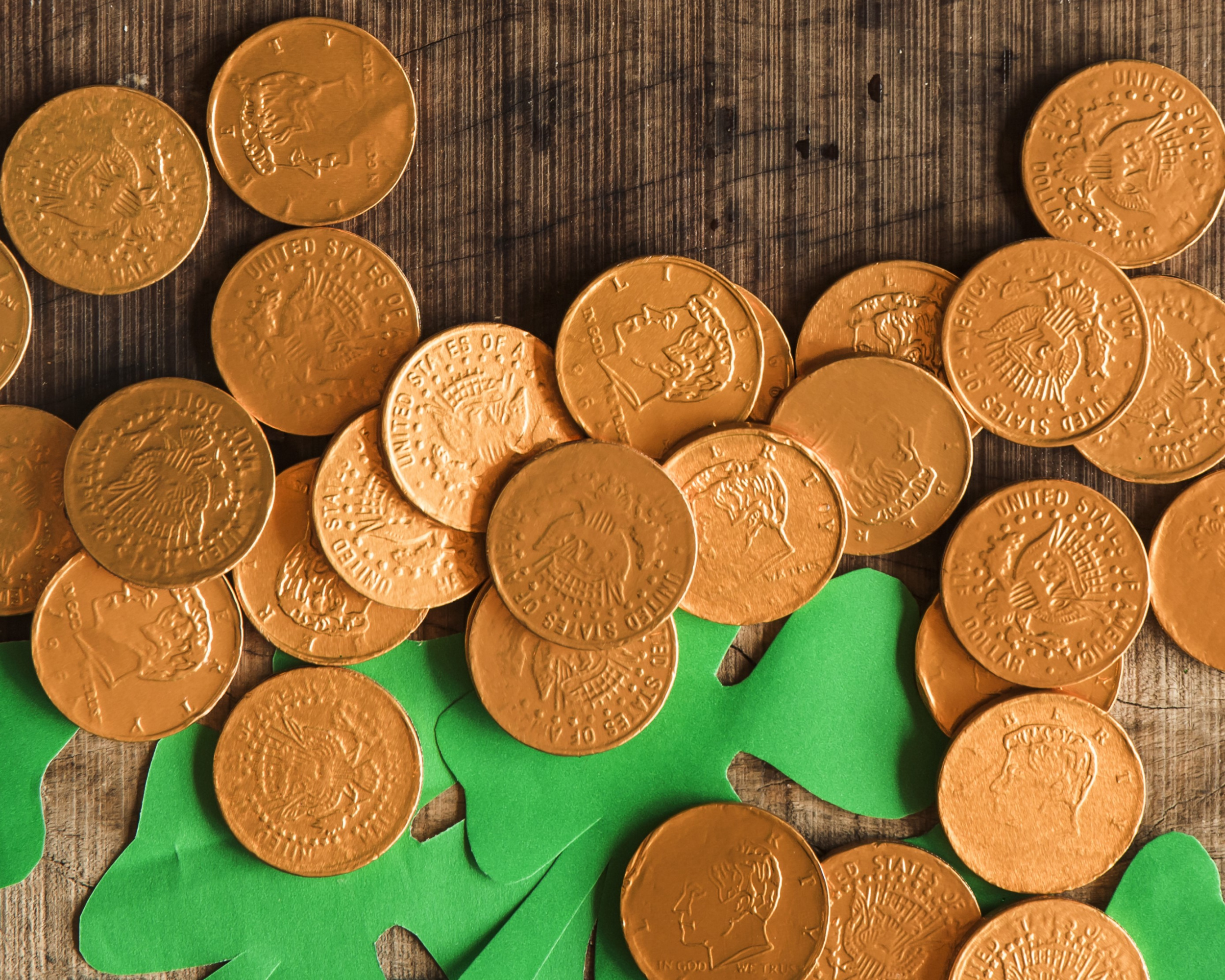heap-coins-paper-shamrocks-wooden-table.jpg